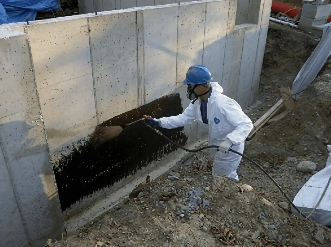 Professional waterproofing the exterior walls of the basement in Spokane, WA