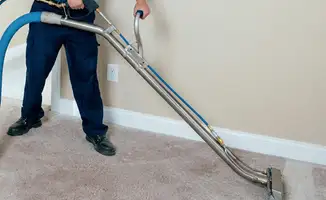 Professional operating a liquid removal machine on a carpeted floor in Spokane, WA